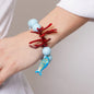 Bracciale in Metallo con sfere azzurre e simboli marini
